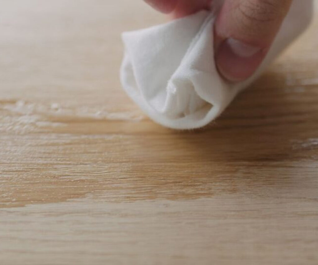Hand polishing wood furniture with a cloth